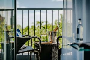 a table with wine bottles and glasses on a balcony at Hotel Kö59 Düsseldorf - Member of Hommage Luxury Hotels Collection in Düsseldorf