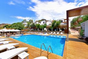 a swimming pool with lounge chairs and a resort at Moon Beach&Hotel in Bodrum City