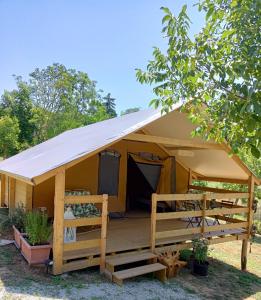 a large tent with a porch in a yard at Resort Orizzonti Glamping in SantʼElpidio a Mare