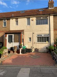 a house with a brick driveway in front of it at London retreat in Golders Green