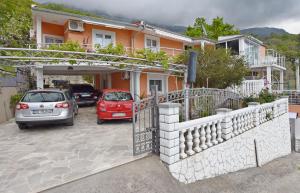 a couple of cars parked in front of a house at Apartments Siljak in Petrovac na Moru