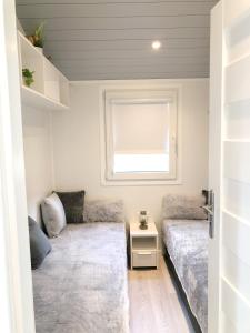 a small living room with a couch and a window at Luxus Ferien-Lodge Lurger-Fasching in Rohrbach An Der Gölsen