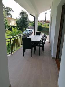 patio con mesa y sillas en el balcón en Villa El Encinar de Noja en Noja