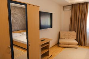 a room with a bedroom with a bed and a chair at Motel Lav in Čapljina +43 photos