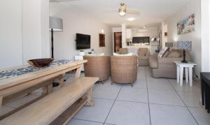 a living room with a table and a couch at 7 The Shades Umhlanga Rocks in Durban