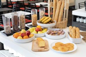 a table with bowls of different types of food at Holiday Inn Express Toulon - Est, an IHG Hotel in Toulon