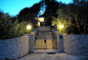 a house with a gate and a stone wall at House Vinka in Selca +27 photos