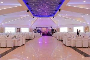 a large banquet hall with white tables and chairs at Motel Lav in Čapljina