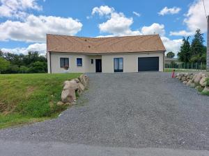 a house with a driveway in front of it at le pavillon in Bonnat
