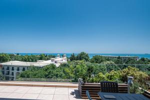a view of the ocean from the balcony of a house at Romance Hotel and Family Suites in Saints Constantine and Helena