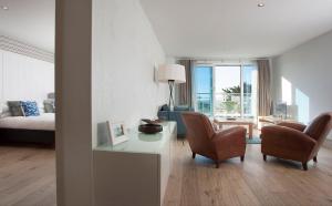 a living room with a couch and a table and chairs at St Moritz Hotel and Cowshed Spa in Polzeath