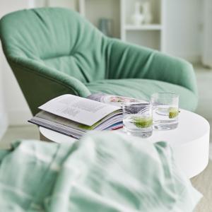 a table with glasses and a book on a chair at St Moritz Hotel and Cowshed Spa in Polzeath