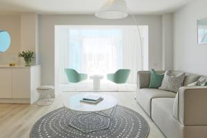 a living room with a couch and a table at St Moritz Hotel and Cowshed Spa in Polzeath