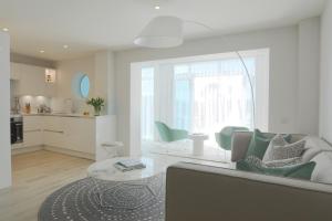a living room with a couch and a table at St Moritz Hotel and Cowshed Spa in Polzeath