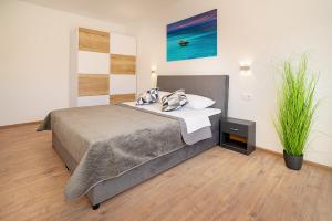 a bedroom with a bed with pillows on it at Apartments Gerta with Terrace in Baška