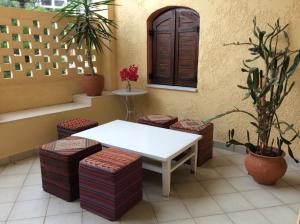 a white table and some stools in a room at Villa Anna in Syvota
