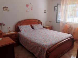 a bedroom with a bed and two tables and a window at Casa a Gallipoli a 1 minuto dal mare in Gallipoli