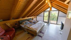 a bedroom with a bed in a wooden house at Appartement Lena in Weissach Im Tal