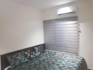 a bedroom with a bed in a room at SBJ Place East Legon in Accra