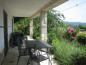 a table and chairs on a patio with flowers at Apartma Janja in Portorož