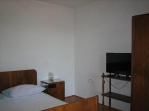 a bedroom with a bed and a flat screen tv at Apartma Janja in Portorož