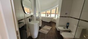 a bathroom with a sink and a tub and a toilet at BUCIUM CLUB VILA 1 in Iaşi +17 photos