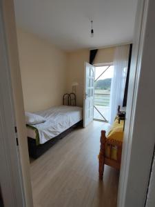 a bedroom with a bed and a sliding glass door at House of the Rising Sun in Bosanska Gradiška