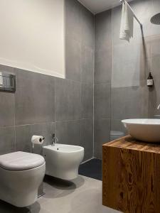 a bathroom with a white toilet and a sink at Hotel Da Franco e Adriana in Pieve Di Ledro