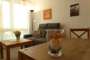 a living room with a table with a vase on it at Ferienhaus Gruebsch in Zempin