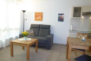 a living room with a couch and a table at Ferienhaus Gruebsch in Zempin +8 photos