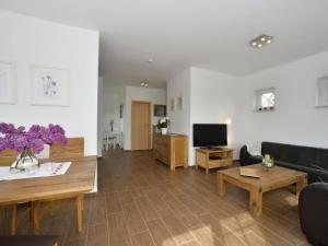 a living room with a couch and a tv at Villa Fasan in Trent