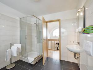 a bathroom with a glass shower and a sink at Villa Fasan in Trent +8 photos