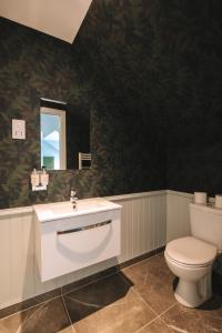 a bathroom with a white toilet and a sink at The Seafield Arms-Cullen in Cullen