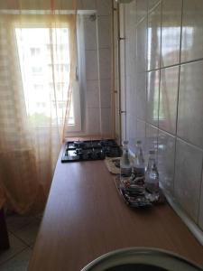 a kitchen with a counter with a stove and a window at Lacul Tei Residence in Bucharest