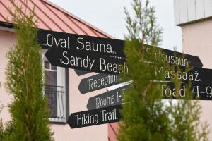 a street sign with arrows pointing in different directions at Ööbikuoru Villa in Rõuge