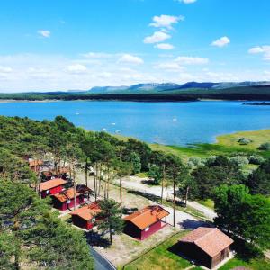 an aerial view of a lake with houses at Camping Urbion in Abejar