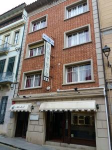 a red brick building with a sign on it at Hotel Wellamar in Sant Feliu de Guíxols
