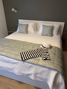 a bed with a hat and a blanket on it at Villa Mali Apartments in Barbat na Rabu +23 photos