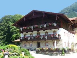 a building with flower boxes on the side of it at Bauernhof Auerhof in Aschau im Chiemgau