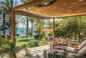 an outdoor patio with a view of the ocean at Amathus Beach Hotel Limassol in Limassol