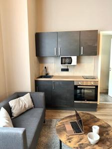 Una sala de estar con un sofá y una mesa con una computadora portátil. en Apartment an der Altstadt # 1, en Hameln 3 fotos más
