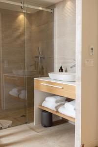 a bathroom with a sink and a glass shower at Cueillette in Altillac