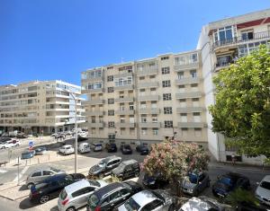 a parking lot with cars parked in front of a building at Aman - Near the beach by HD PROPERTIES in Cavacos