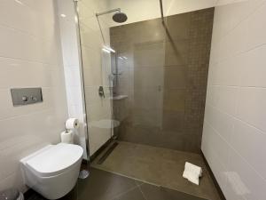 a bathroom with a shower with a toilet and a sink at Aman - Near the beach by HD PROPERTIES in Cavacos +12 photos