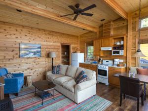 a living room with a couch and a kitchen at Snug Harbor Resort and Marina in Friday Harbor