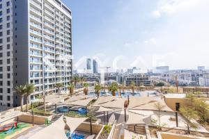 a view of the pool and buildings in the city at Staycae Holiday Homes - Ghalia in Dubai