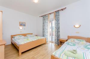 Posteľ alebo postele v izbe v ubytovaní Apartments and Room Ljubica + 37 fotografií