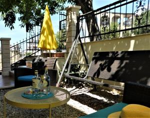 a patio with a table and a yellow umbrella at Apartment Dalmatia Ketty in Makarska