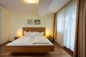 Postel nebo postele na pokoji v ubytování Hotel Garni Bernadette