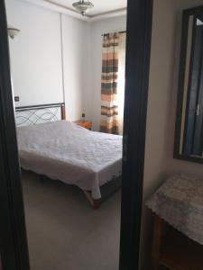 a small bedroom with a bed and a window at Bel appartement meublé B 16 in El Jadida +9 photos
